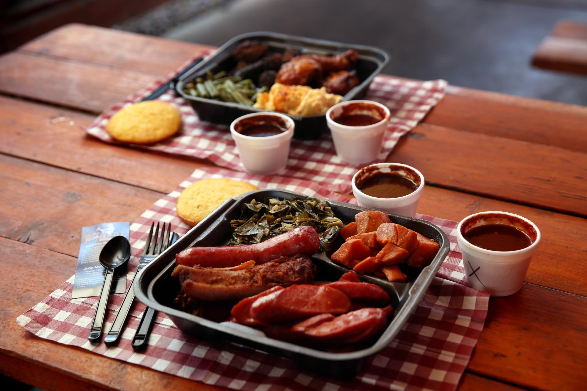A dinner plate of hot links, collard greens and yams at John Mull's Meats & Road Kill Grill on in Las Vegas.