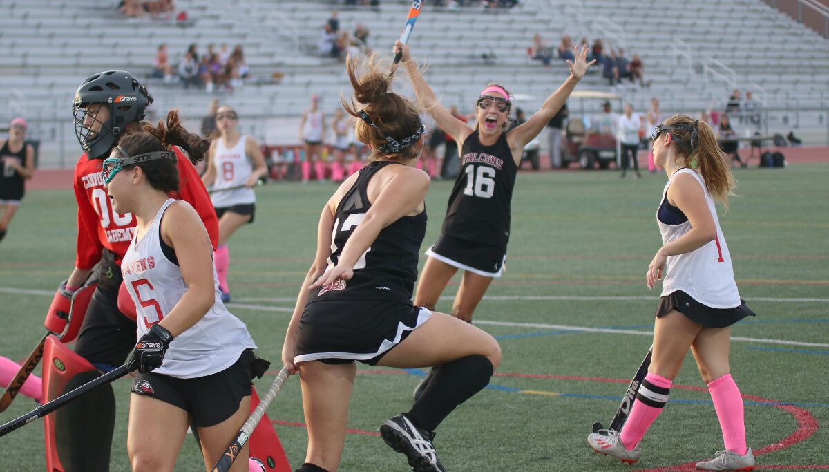 Stella Mikolajewski (#16) and Hailey Dewey (foreground) celebrate the game's first goal.