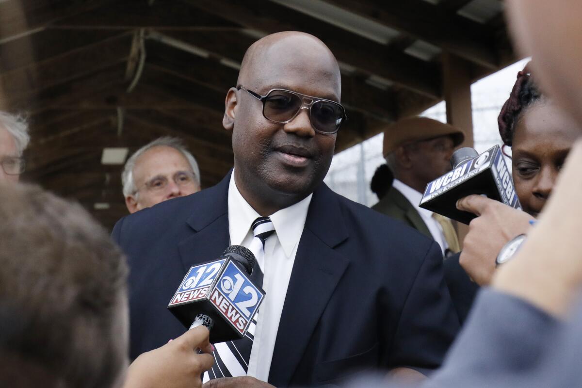 FILE - In this Dec. 16, 2019 file photo, Curtis Flowers speaks with reporters as he exits the Winston-Choctaw Regional Correctional Facility in Louisville, Miss. Flowers freed after nearly 23 years in prison is suing the district attorney who prosecuted him six times in the killings of four people at furniture store. Attorneys for Flowers filed the lawsuit Friday, Sept. 3, 2021, seeking an unspecified amount of compensation. (AP Photo/Rogelio V. Solis, File)