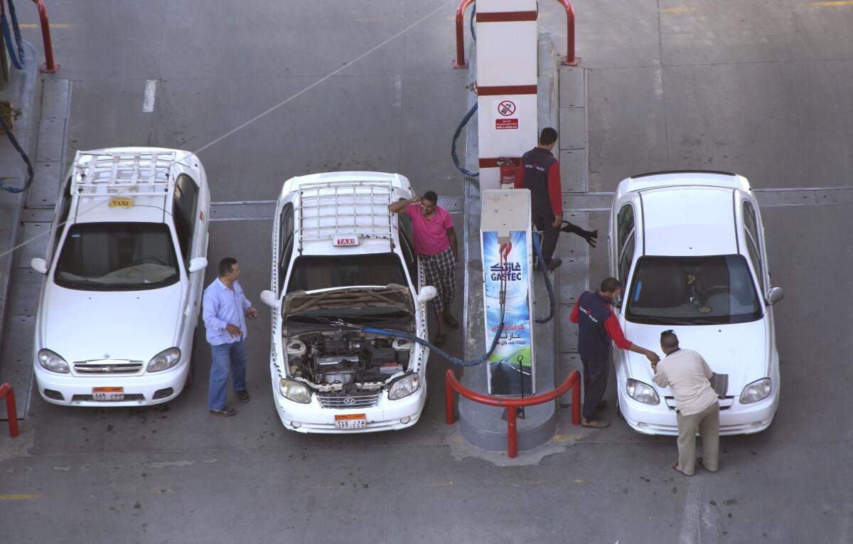 FILE - Taxi drivers chat as they refuel their vehicles at a gas station in Cairo, Egypt, June 29, 2017. The Egyptian government on Wednesday, July 13, 2022, increased the price of its widely-used diesel and other fuels, in a move that is expected to further drive up prices. The country, like others around the world, is facing steep inflationary pressures in the wake of Russia’s war on Ukraine. (AP Photo/Amr Nabil, File)