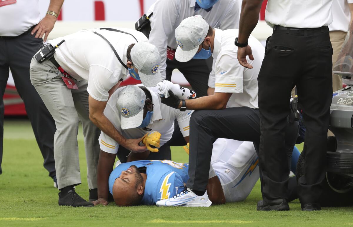 Chargers running back Austin Ekeler is attended to after suffering a hamstring injury against the Buccaneers.