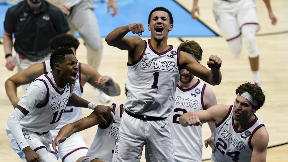 Gonzaga guard Jalen Suggs celebrates with teammates after making the game winning basket 