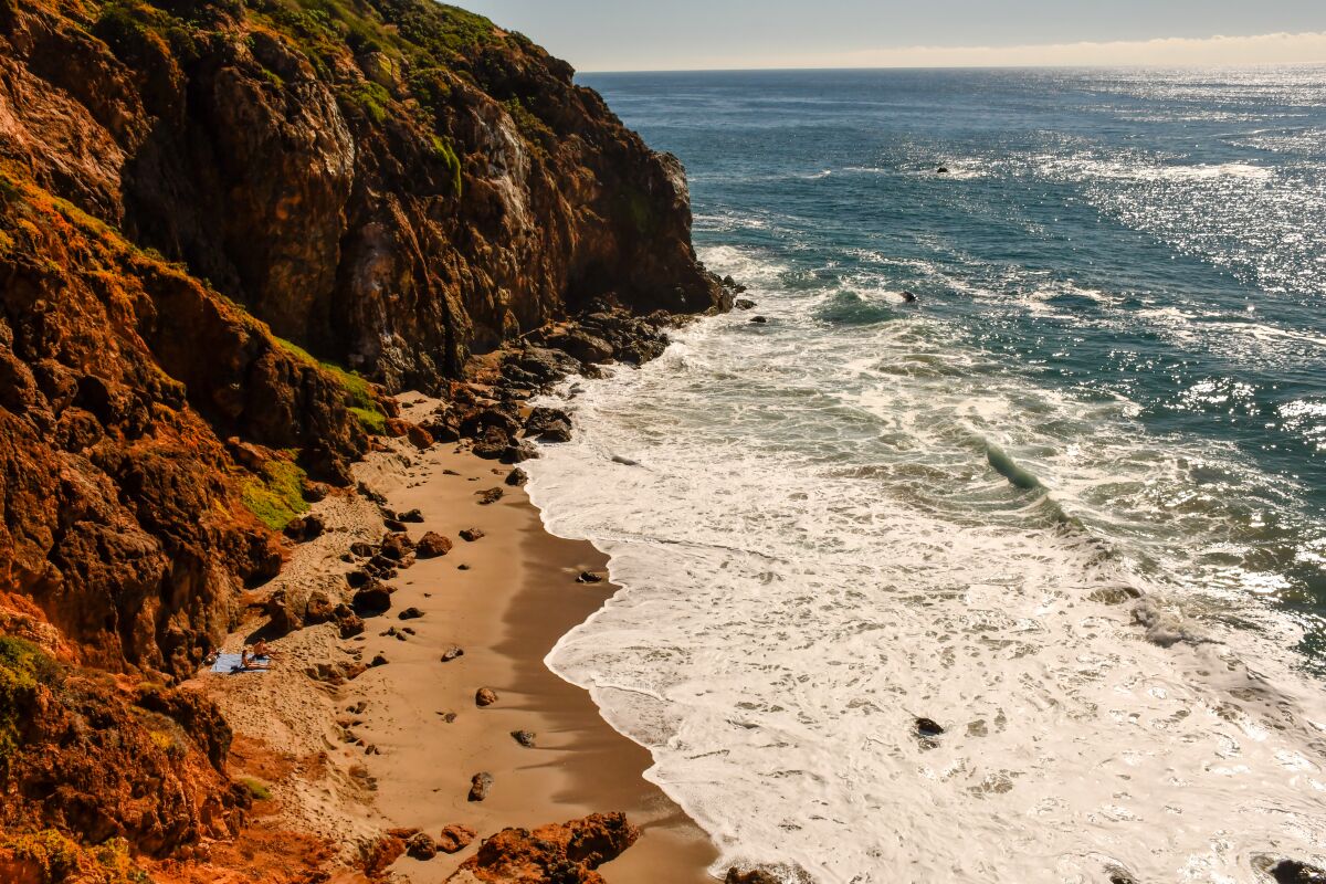 Rocky cliffs loom over the beach at Point Dume State Preserve