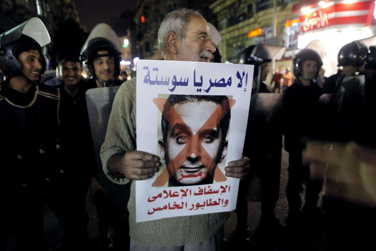 A supporter of Gen. Abdel Fattah Sisi protests comedian Bassem Youssef at a Cairo rally.