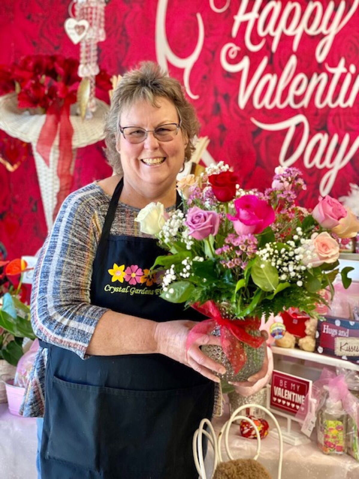 Jeannie Hume, owner of Crystal Gardens Florist in Poway, shows off a Valentine’s Day bouquet.