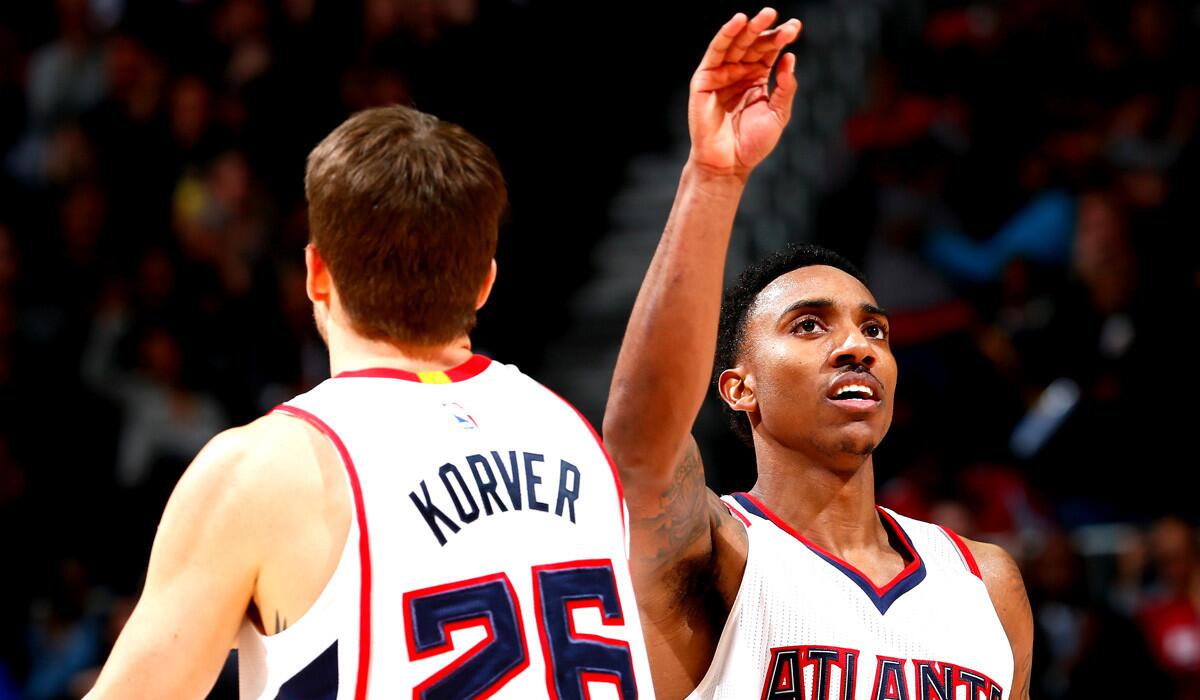 Atlanta's Jeff Teague reacts with teammate Kyle Korver during the Hawks' 96-86 win over the Memphis Grizzlies on Wednesday.