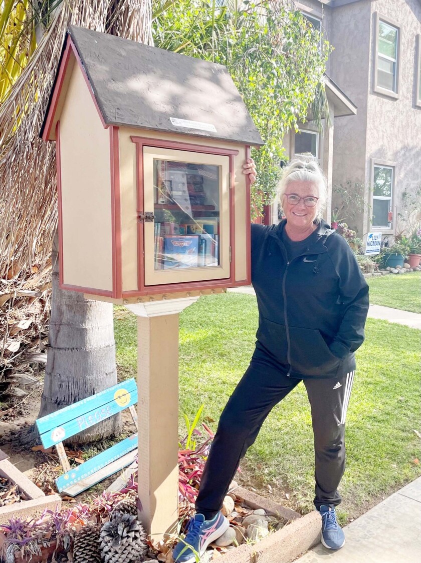 Marie Kracha with her Little Free Library at 1319 Chalcedony St.