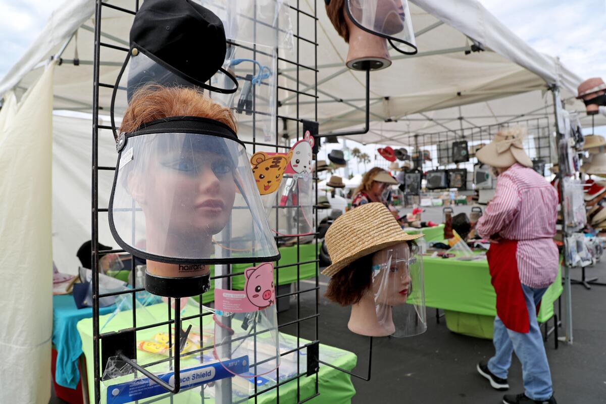 Face shields for sale from Monique's Boutique during the Costa Mesa Farmers Market at the OC Fair & Event Center Thursday.