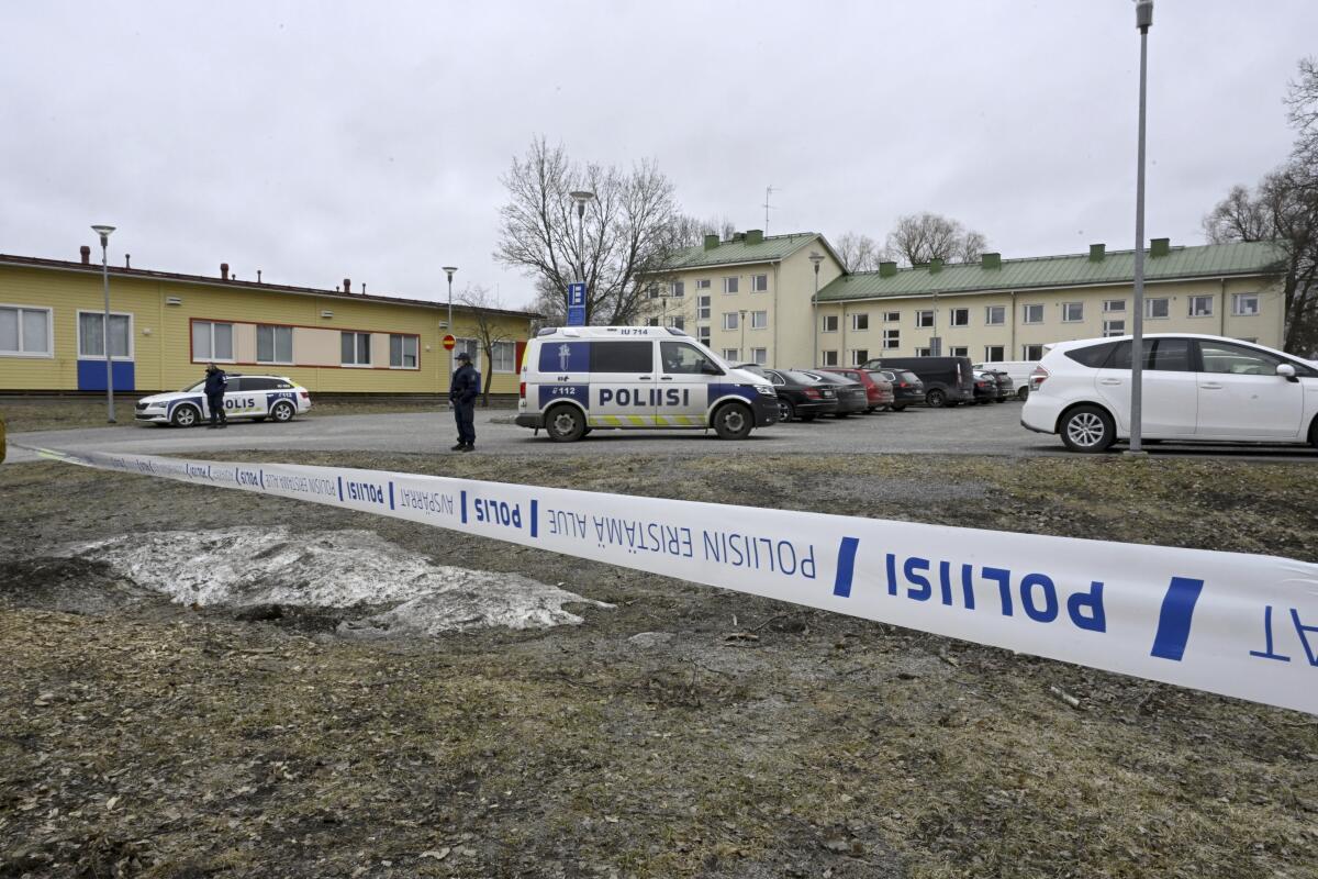 Police officers stand guard outside Viertola comprehensive school, in Vantaa, Finland.