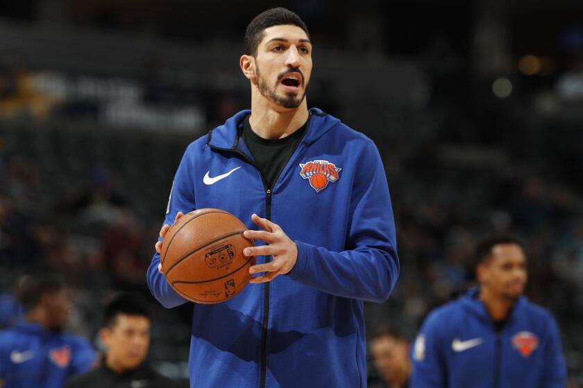 FILE - In this Jan. 1, 2019, file photo, New York Knicks center Enes Kanter, of Turkey, warms up prior to the team's NBA basketball game against the Denver Nuggets, in Denver. Turkish media reports said Wednesday, Jan. 16, 2019, that Turkish prosecutors are seeking an international arrest warrant and had prepared an extradition request for Kanter, accusing him of membership in a terror organisation. Sabah newspaper said prosecutors were seeking an Interpol "Red Notice" citing Kanter's ties to Fethullah Gulen, who Turkey blames for a failed 2016 coup, and accusing him of providing financial support to the group. (AP Photo/David Zalubowski, File)