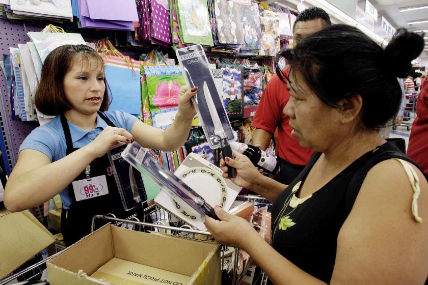 Marta Lara,left, helps Anita Hernandez at 99 Cent Store, in Los Angeles Monday, Sept 8, 2008. The discount retailer announced Monday the first price increase in the chain's 26-year history by raising the cost of household items, food and other items by almost a penny. The company blamed rising inflation, food and energy prices for the new 99.99 cent price. (AP Photo/Nick Ut)