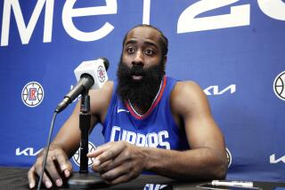 James Harden responds to a reporter's question as he is introduced as the newest member.