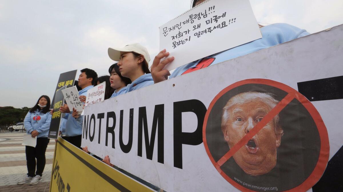 South Korean protesters stage a rally against a planned visit by President Trump, near the presidential Blue House in Seoul on Nov. 1, 2017.