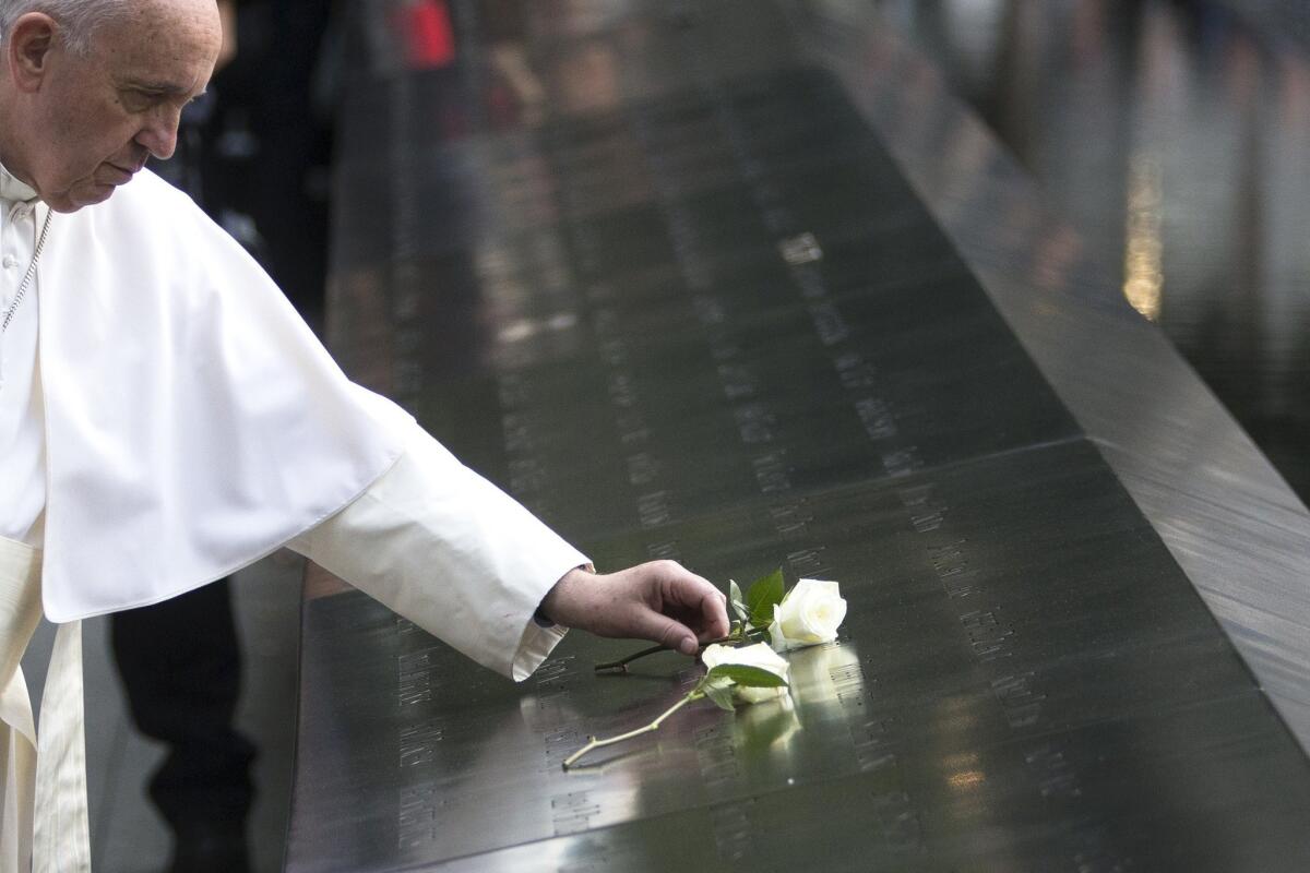 Pope Francis places a white rose at the south pool of the 9/11 Memorial in downtown Manhattan.