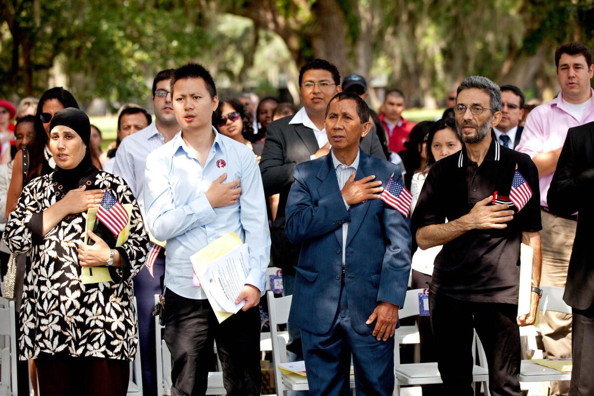 New American citizens recite the Pledge of Allegiance during a naturalization ceremony in Charleston, S.C., in 2010. South Carolina was home not long ago mostly to families with deep Southern roots. Many worked in its textile mills and peach orchards. In the last decade, Latinos and other immigrants increasingly have arrived, and tiendas and taquerias have sprung up in some areas.