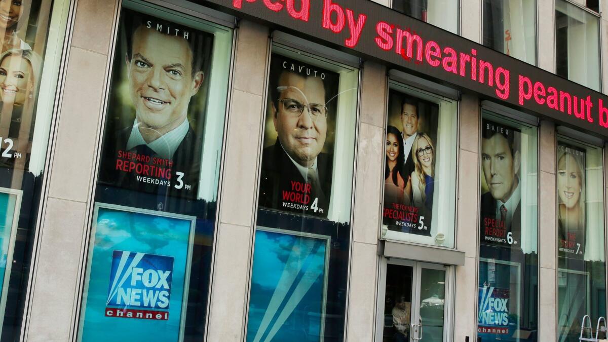 Headlines scroll above the Fox News studios in the News Corp. headquarters building in New York.