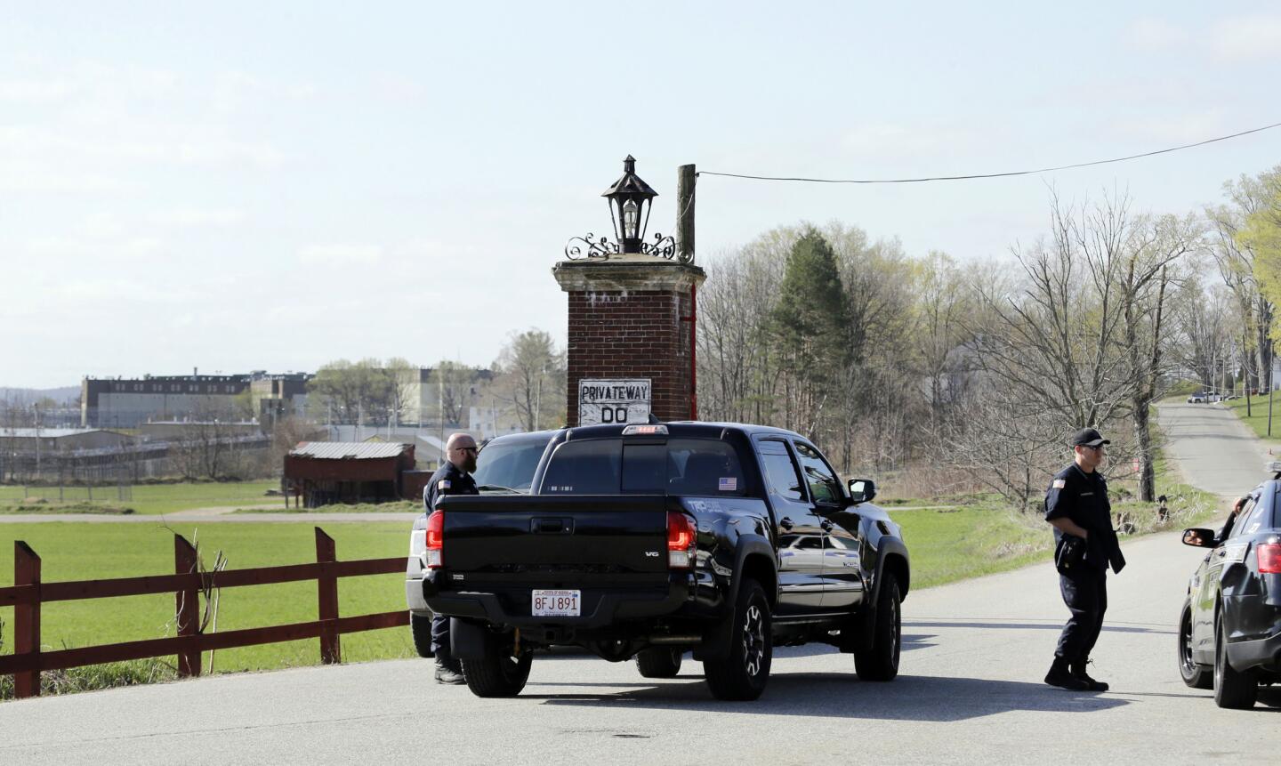 Police guard an entrance to the Souza-Baranowski Correctional Center, Wednesday, April 19, 2017, in Shirley, Mass. Former NFL star Aaron Hernandez, who was serving a life sentence for a murder conviction and just days ago was acquitted of a double murder, died after hanging himself at his prison cell early Wednesday, Massachusetts prisons officials said.