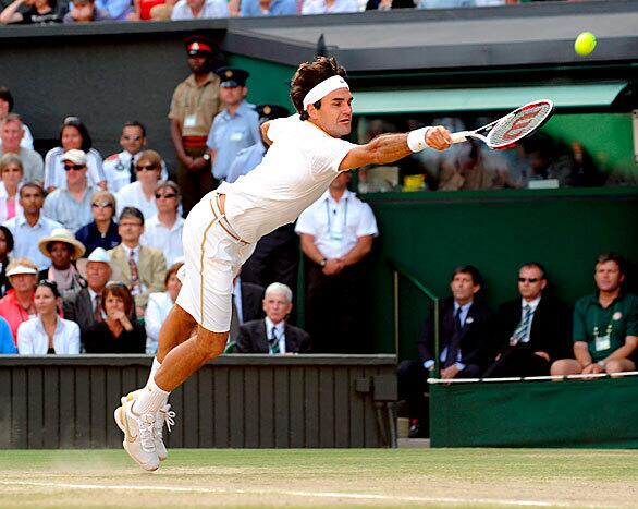 Federer, of Switzerland, returns to his U.S. opponent, Roddick during their men's singles final match for the Wimbledon Championships at the All England Lawn Tennis Club.