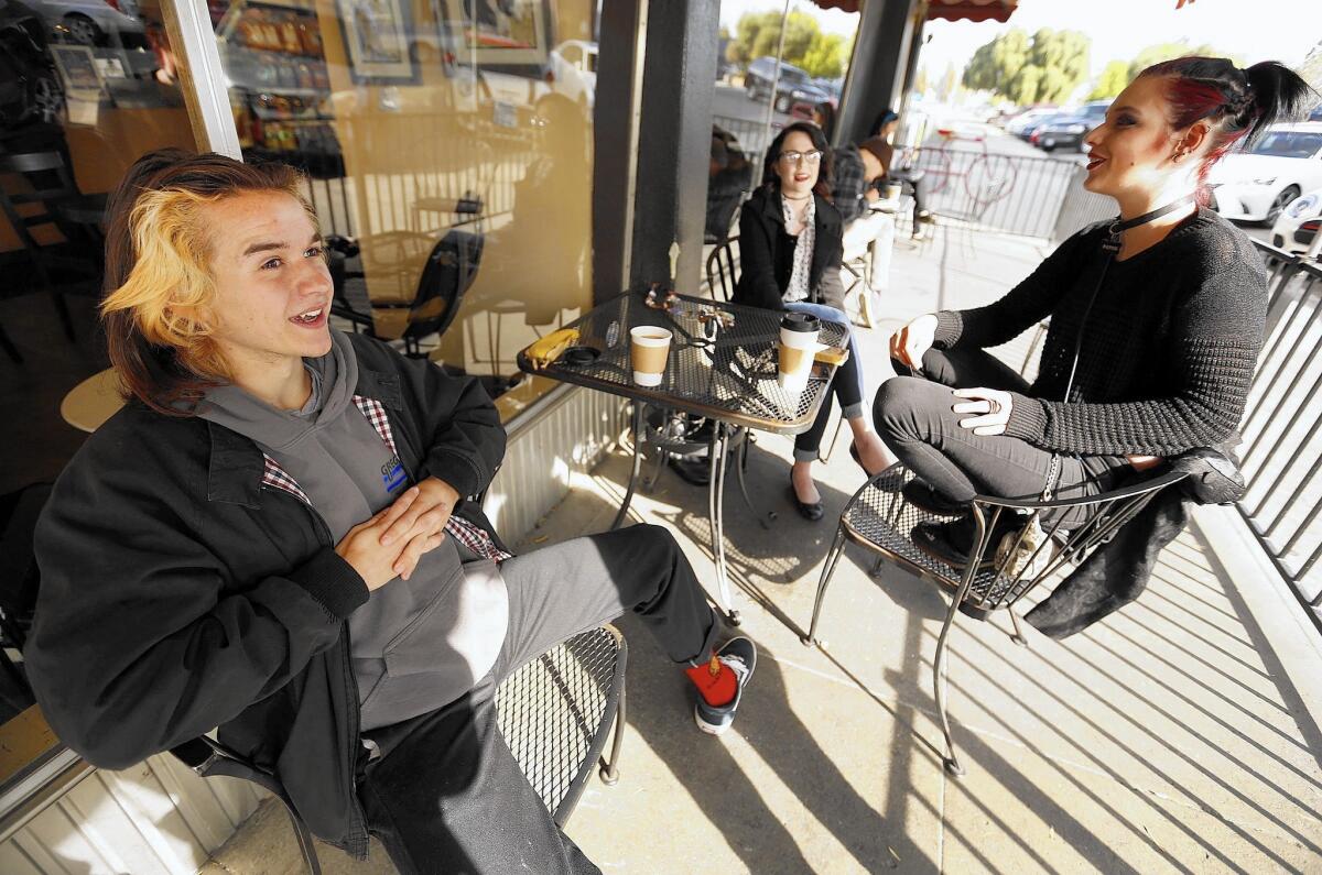 Jason Powers, 19, from left, Cyrena Jones, 18, and Erika Davis, 19, talk about Donald Trump outside Dagny's Coffee Co. in downtown Bakersfield. They say they oppose the GOP presidential candidate's views but believe their parents will agree with some of his stances.