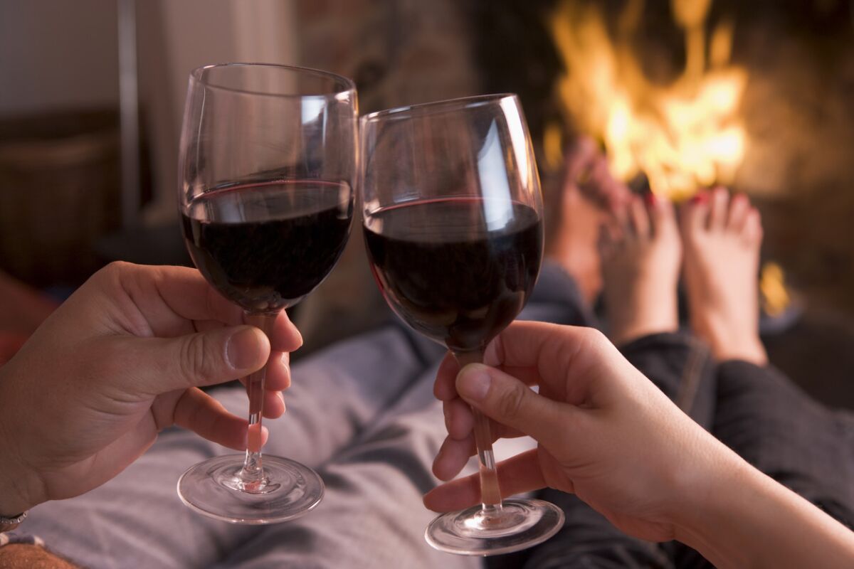 Cozy up next to the fire and make sure to bring one of these top red wines for cold weather. (iStock)