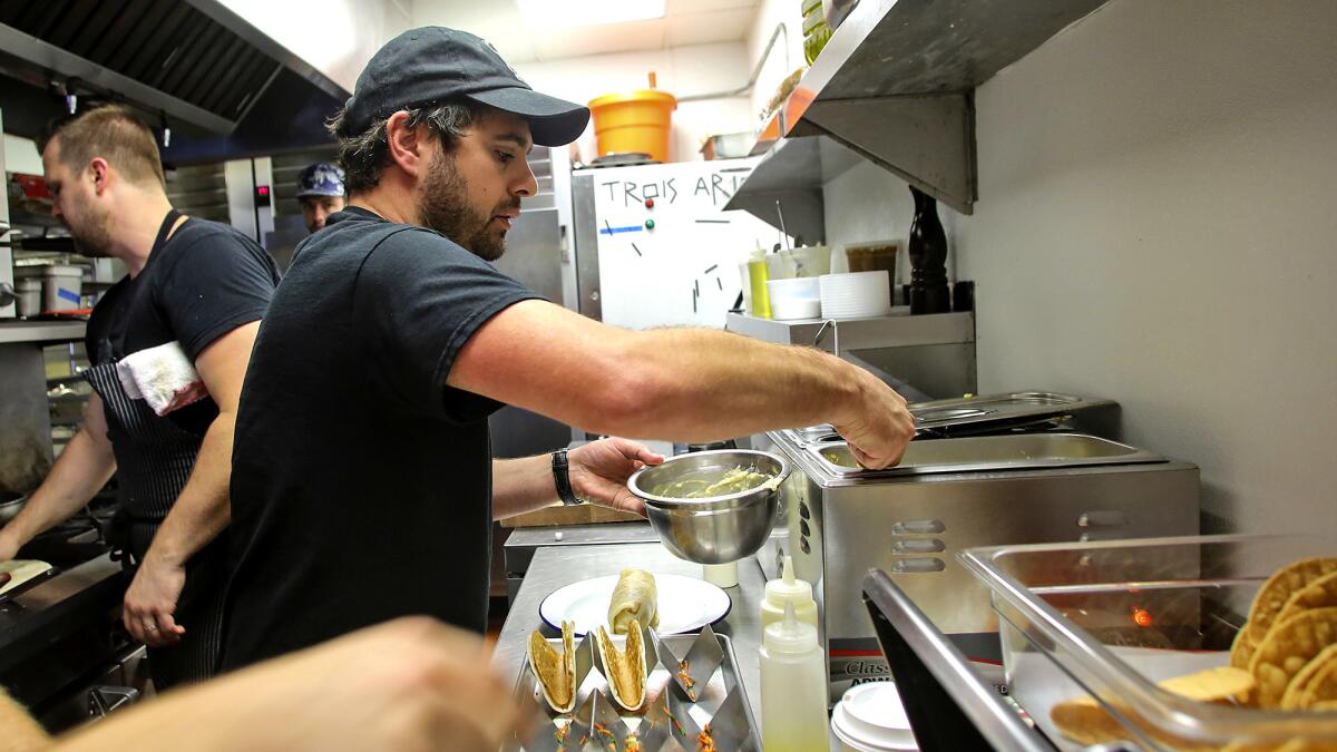Chef Jon Shook, at Trois Familia in Silver Lake, operates six restaurants with his business partner.
