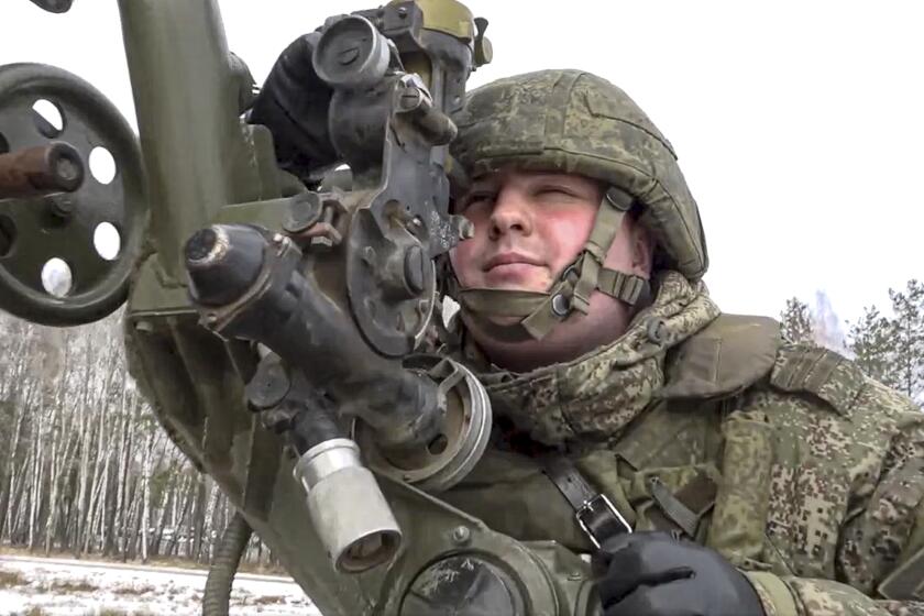 In this photo taken from video and released by the Russian Defense Ministry Press Service on Friday, Feb. 4, 2022, a soldier takes part in the Belarusian and Russian joint military drills at Brestsky firing range, Belarus. Russian and Belarus troops held joint combat training at firing ranges in Belarus. The drills involved motorized rifle, artillery and anti-tank missile units, as well tanks and armored personnel carriers crews. (Russian Defense Ministry Press Service via AP)