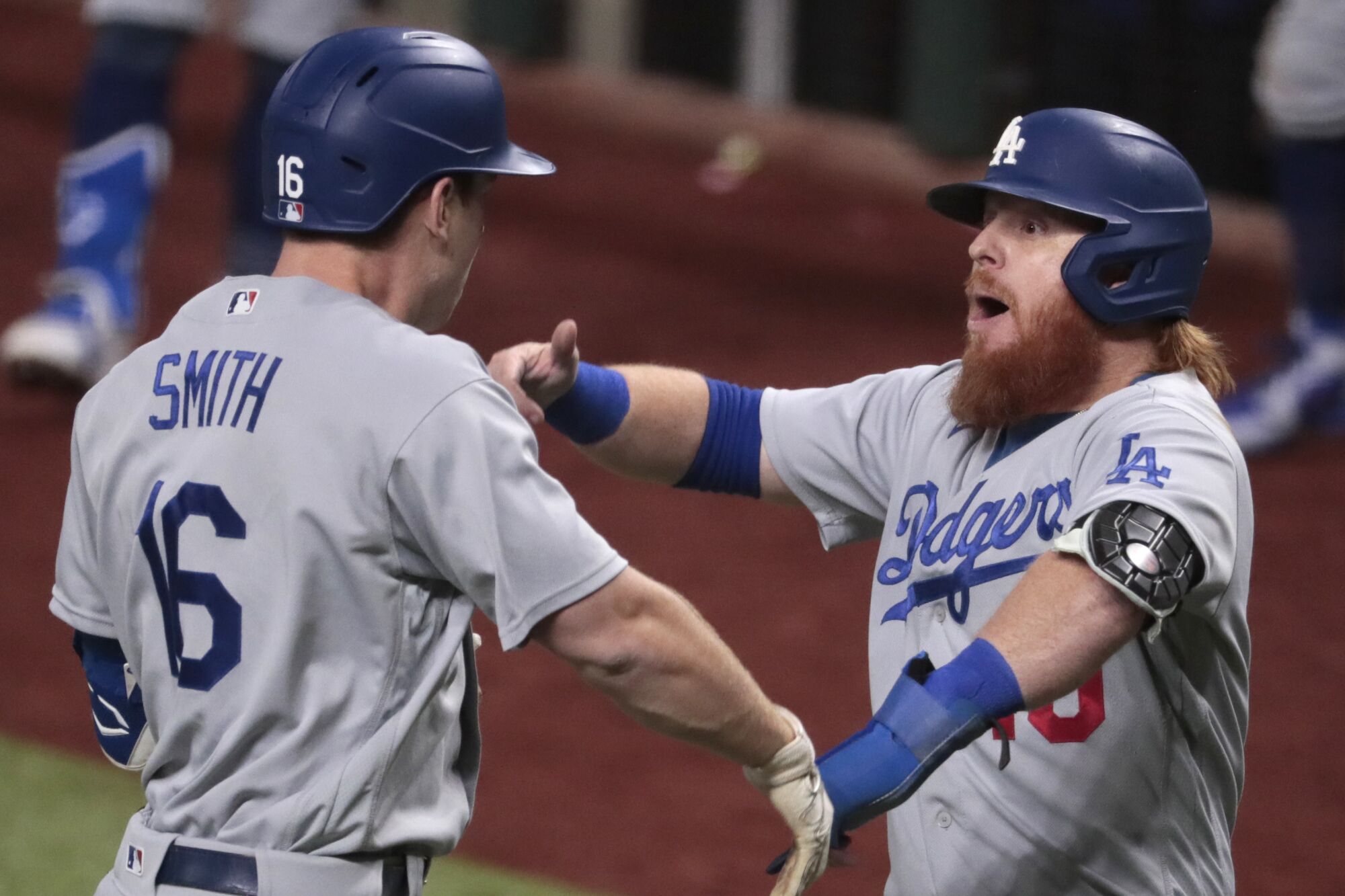 Will Smith, left, celebrates with Dodgers teammate Justin Turner after hitting a three-run home run.