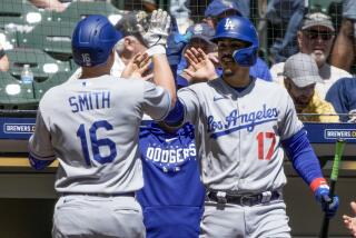 Los Angeles Dodgers' Will Smith is congratulated by Miguel Vargas after hitting a home run.