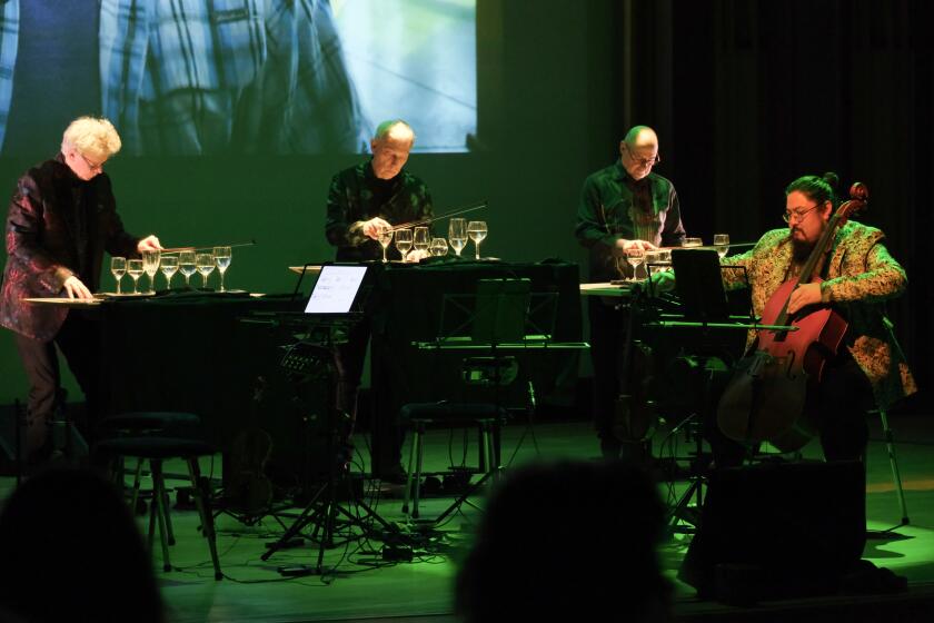 The Kronos Quartet performs by playing glasses of water with their instrument bows.
