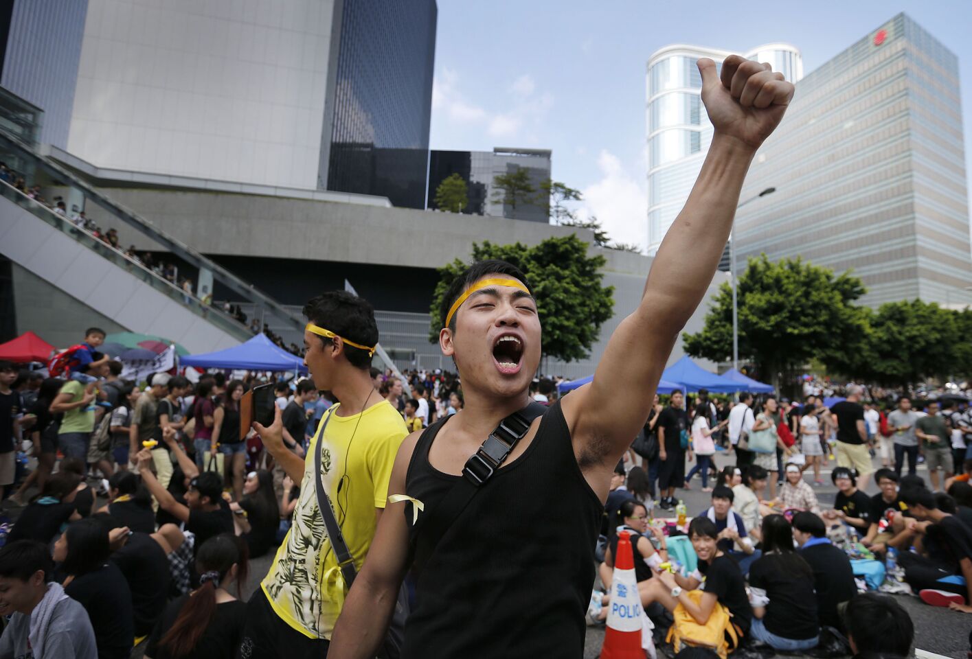 A pro-democracy activist shouts slogans on a street near the government headquarters where protesters have made camp.