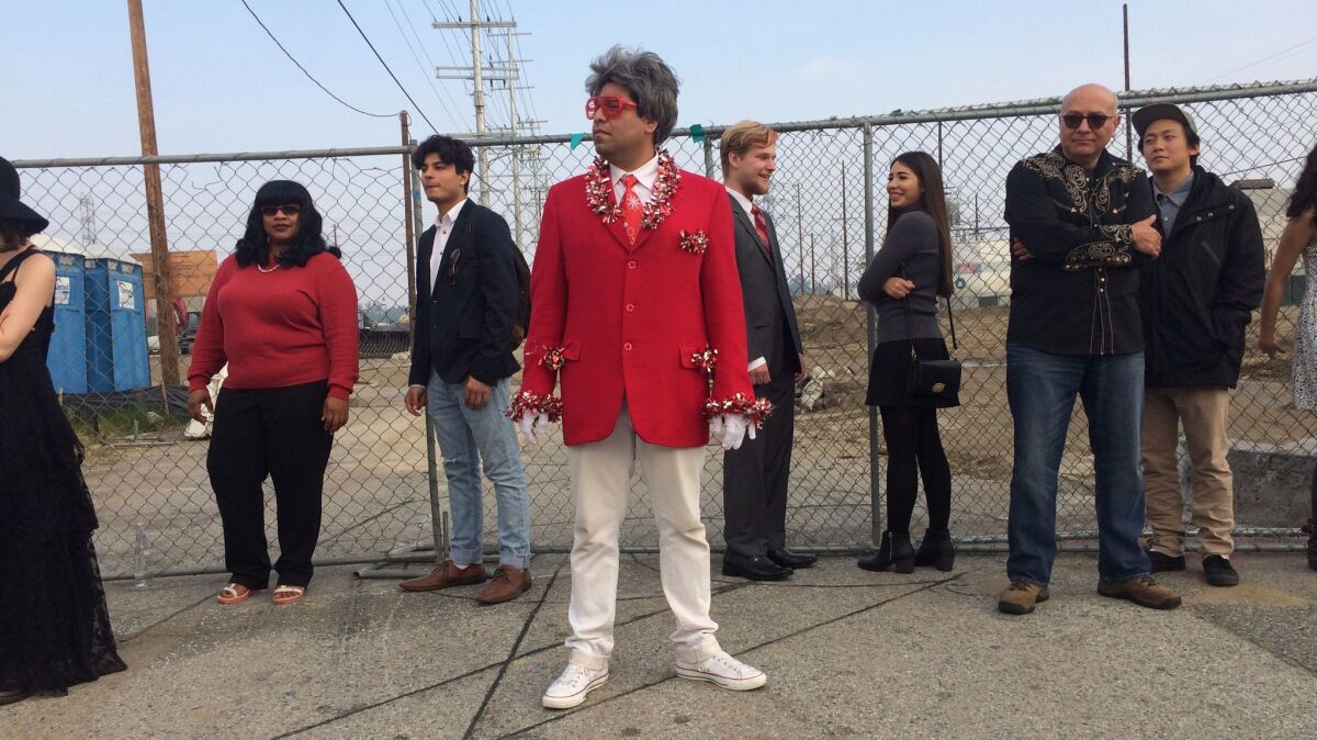 Chris Velasco, in the foreground, dresses up as "Barry," a holiday-loving character