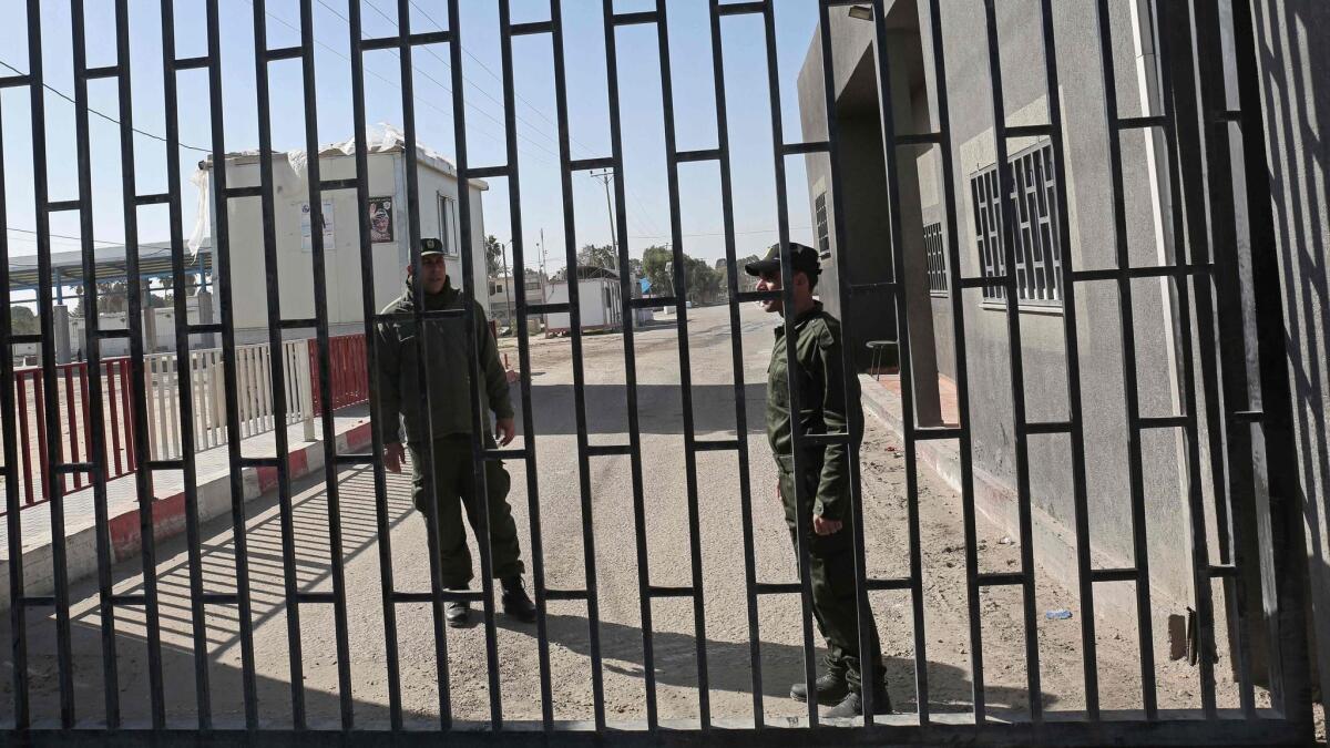 Palestinian security forces stand at the gate of the Kerem Shalom border crossing in the southern Gaza Strip town of Rafat on Sunday after it was closed by Israel following the discovery of tunnels.