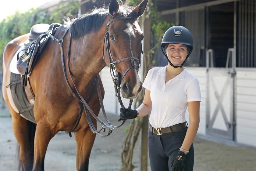 Newport Beach resident Lauren O'Neill, 17, and her horse Clapello at a private horse training barn in San Juan Capistrano on Friday, April 24. O'Neill recently launched a non-profit called Hooves and Hope, a necklace brand that combines her love of design and horses, as well her passion for service. A hundred percent of all sales will go to Feeding America, which feeds over 46 million people by supporting food banks and soup kitchens across the nation. She is a junior in high school at the Waldorf School of Orange County in Costa Mesa.