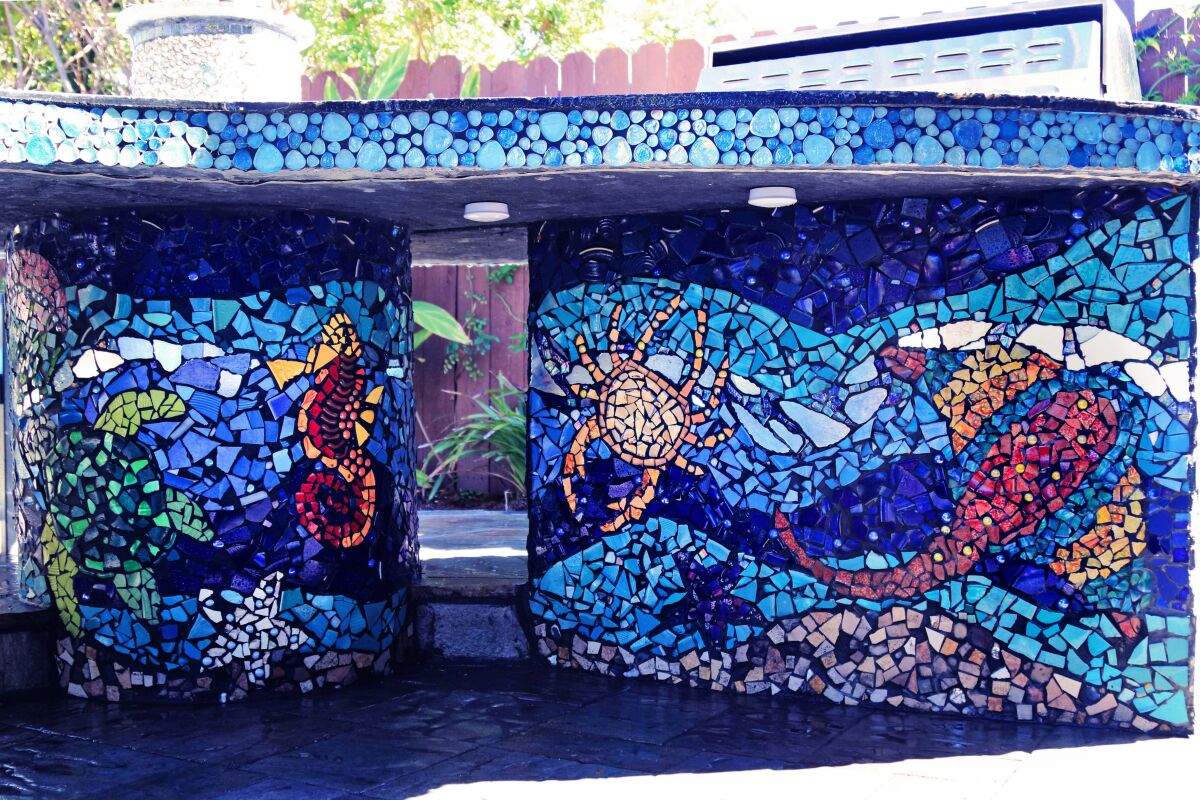 Amy and Donald Miller's contractor built a large concrete table, and they covered it with bright mosaics of the ocean.