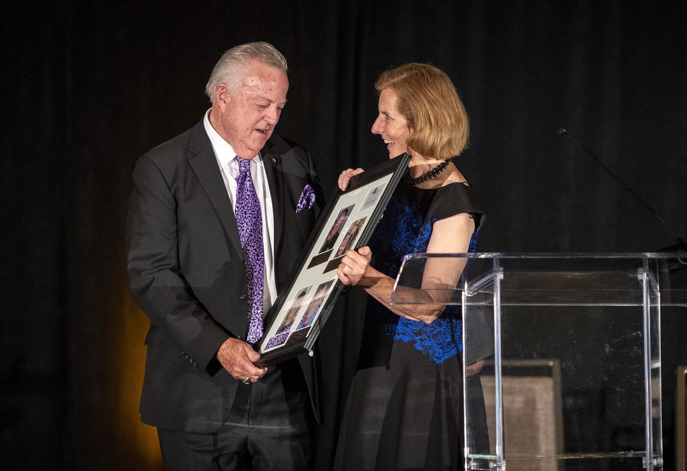 Costa Mesa Mayor Sandy Genis presents former police chief Dave Snowden with the Art of Leadership award during the annual Art of Leadership Mayor's Celebration dinner Thursday.