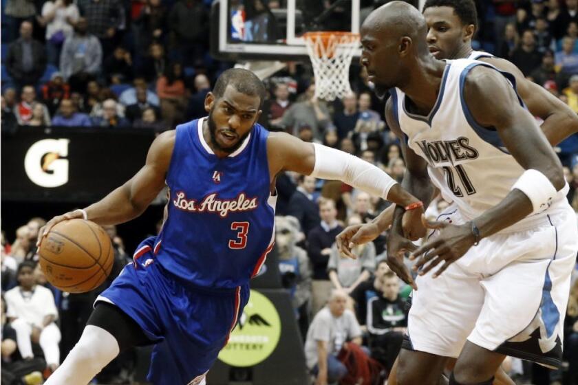 Timberwolves forward Kevin Garnett tries to cut off a drive by Clippers point guard Chris Paul during a game last season.