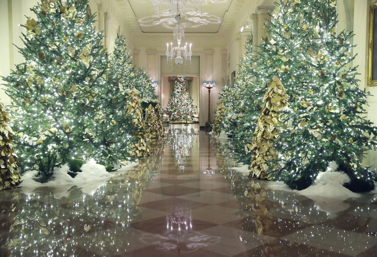 The Grand Foyer of the White House, bedecked with trees.