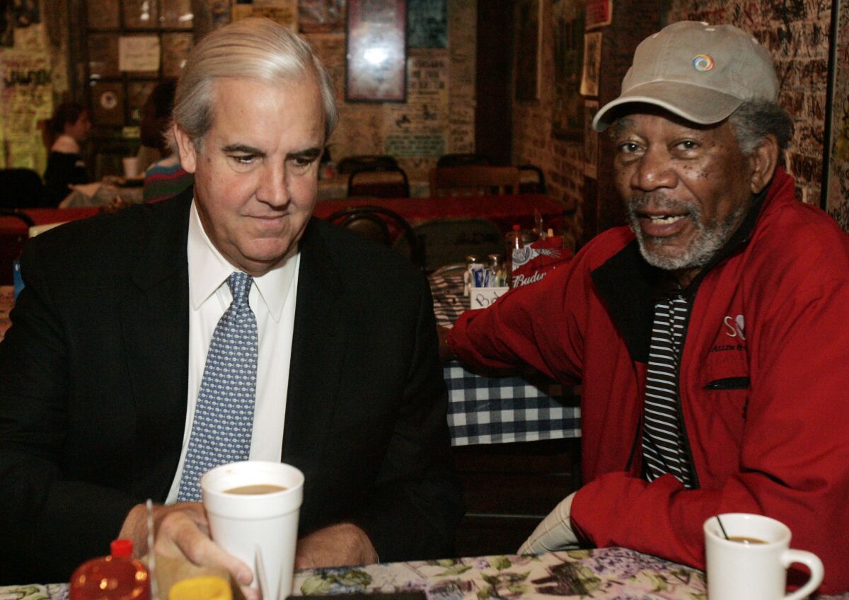 FILE - Actor Morgan Freeman, right, and his business partner Bill Luckett are shown during an interview at Ground Zero Blues Club in Clarksdale, Miss., Oct. 11, 2009. Bill Luckett was an attorney, small-town mayor, candidate for governor, blues promoter, friend and business partner of Morgan Freeman and irrepressible teller of tales about the people and culture of his beloved Mississippi. Luckett died Thursday, Oct. 28, 2021, a year after being diagnosed with cancer. He was 73. (AP Photo/Rogelio V. Solis, File)