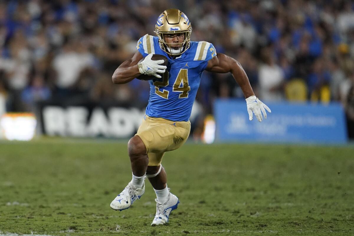 UCLA running back Zach Charbonnet runs with the ball against Washington.