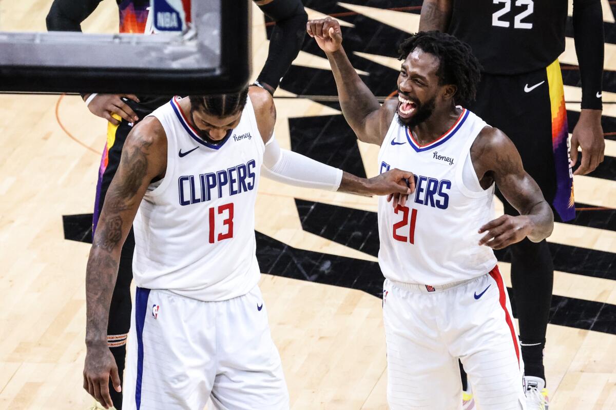 Patrick Beverley, right, jokes with Paul George before he attempts technical free throws after suffering a flagrant foul.