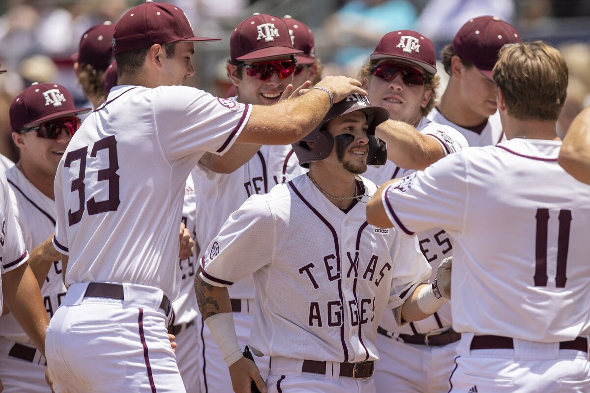 Texas A&M's Jordan Thompson celebrates his two-run home run with teammates against Oral Roberts in an NCAA college baseball game at the College Station Regional in College Station, Texas, Friday, June 3, 2022. (Michael Miller/College Station Eagle via AP)