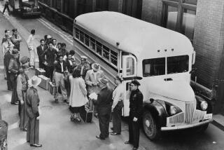 1949 photo of undocumented immigrants board bus for deportation to Mexico.