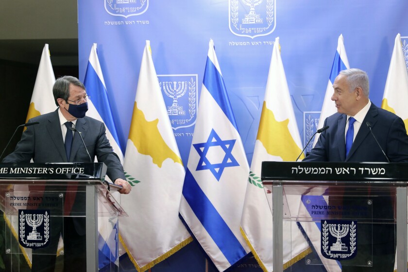 Cyprus President Nicos Anastasiades, left, and Israeli Prime Minister Benjamin Netanyahu deliver statements after meeting in Jerusalem, Sunday, Feb. 14, 2021. (Marc Israel Sellem/Pool via AP)