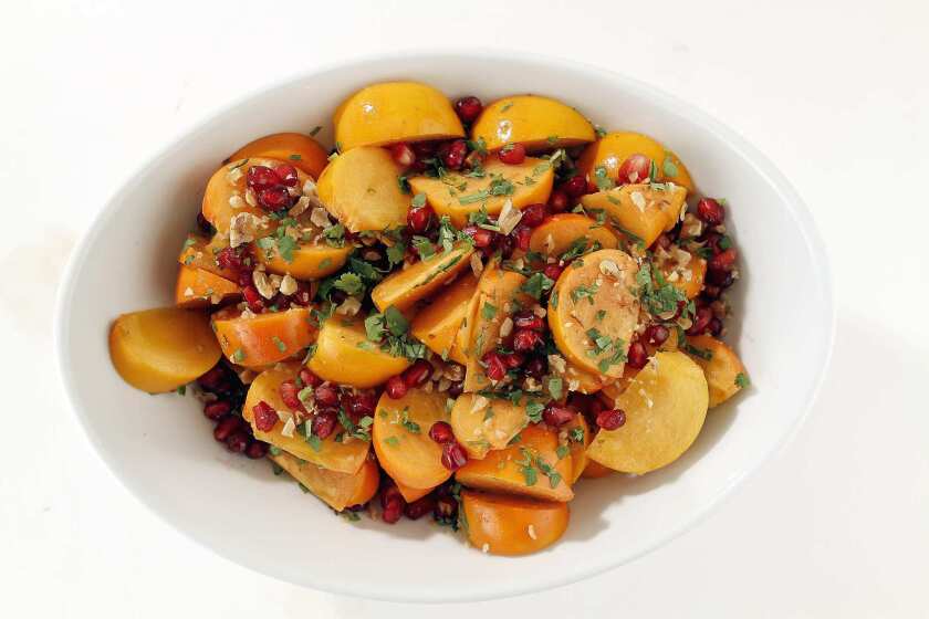 Fuyu persimmon salad with cumin-lime vinaigrette.