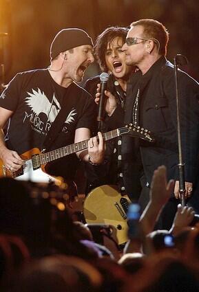 Bono, right, and The Edge, left of U2 and Billie Joe Armstrong of Green Day perform prior to the Monday Night Football game between the Atlanta Falcons.