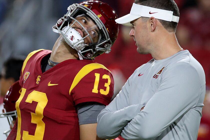 LOS ANGELES, CALIF. - OCT. 1, 2022. USC head coach Lincoln Riley talks with quarterback Caleb Williams before the game against Arizona State at the Los Angeles Memorial Coliseum on Saturday night, Oct. 1, 2022. (Luis Sinco / Los Angeles Times)