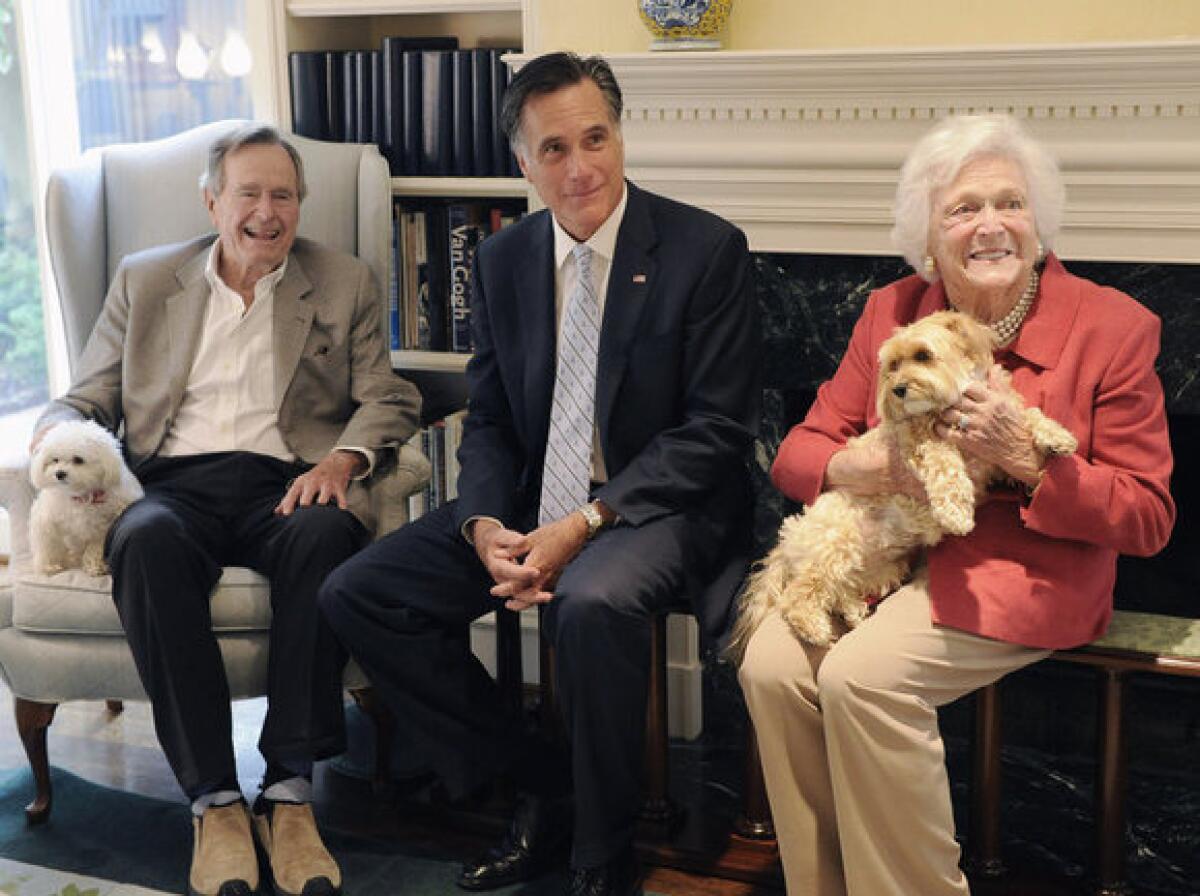 Mitt Romney visits with former President George H.W. Bush, his wife, Barbara, and their dogs Mimi and Bibi at their home in Houston.