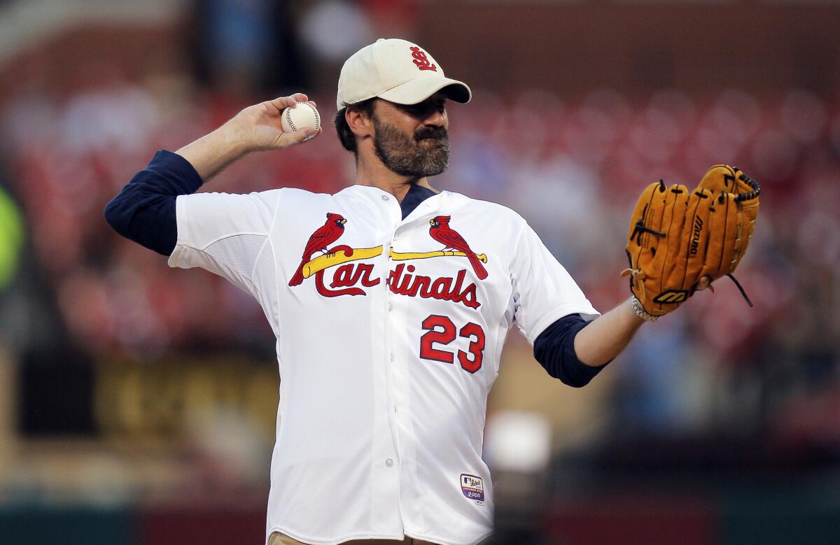 Missouri native Jon Hamm throws out a ceremonial first pitch before the Monday night game between the St. Louis Cardinals and the Cincinnati Reds in St. Louis.