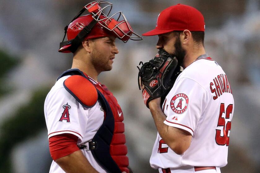 Angels catcher Chris Iannetta talks to pitcher Matt Shoemaker during a game against the A's on April 20.
