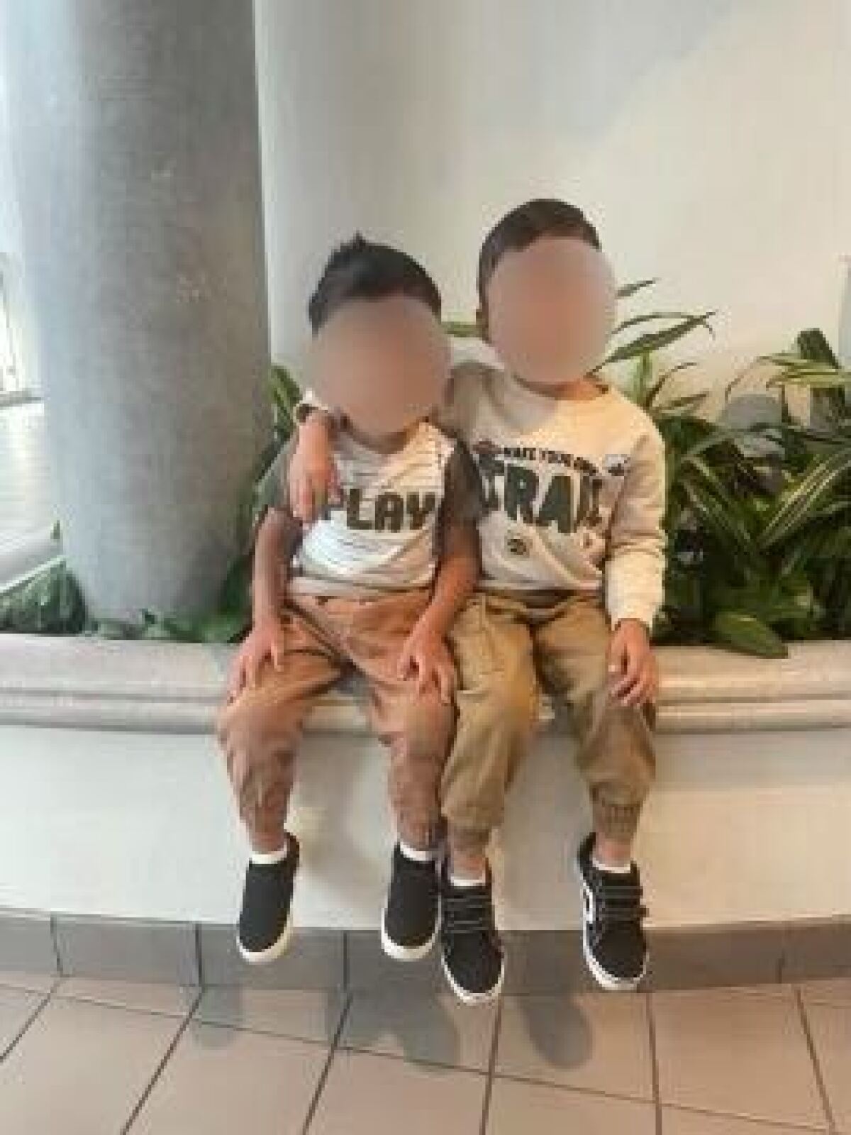 Two young boys in similar outfits